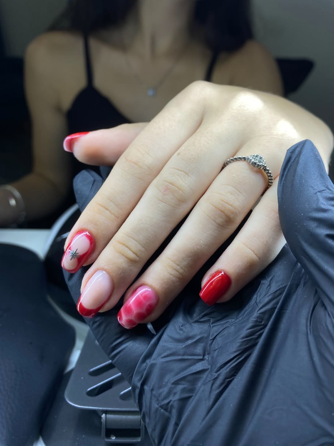 Nail art vermelha com estrela prateada e marmorizado